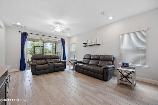 living room with ceiling fan and light hardwood / wood-style floors