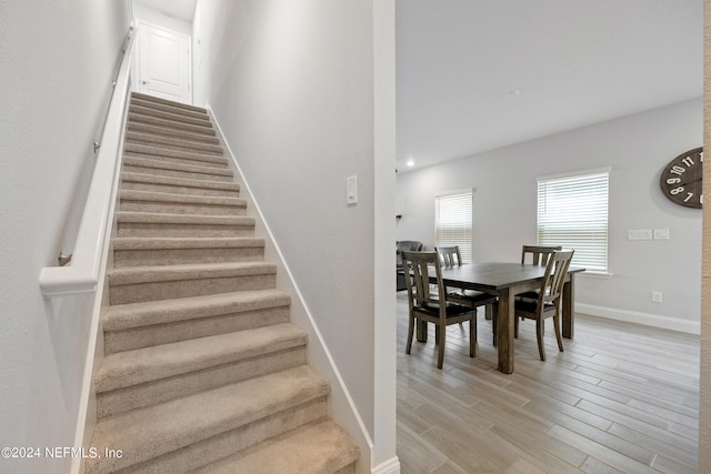 stairs with hardwood / wood-style flooring