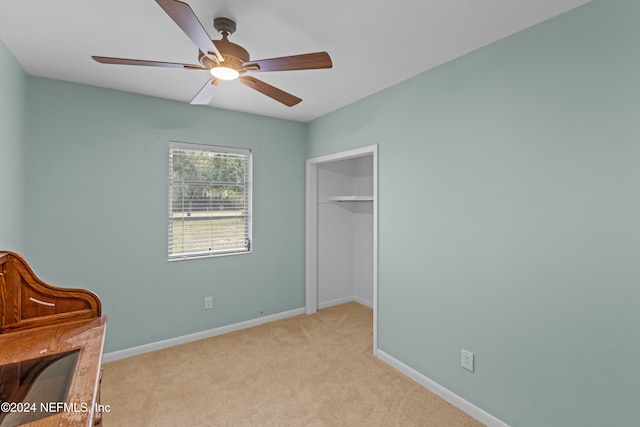 sitting room with ceiling fan and light colored carpet