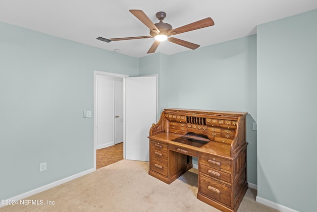 office space featuring ceiling fan and light carpet