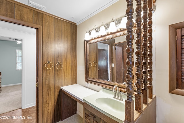 bathroom with vanity and ornamental molding