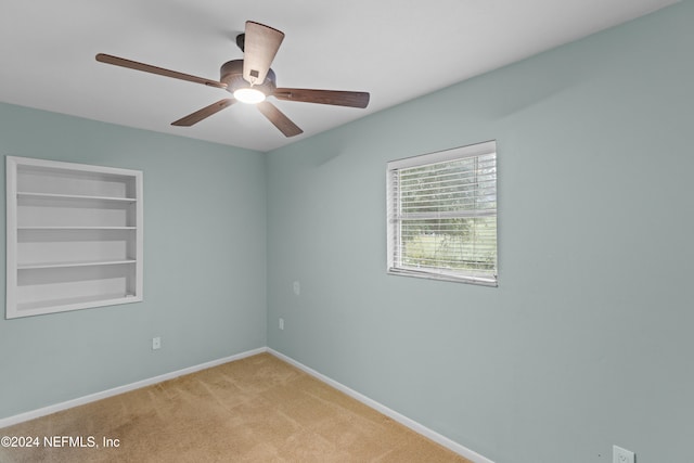 empty room with light carpet and ceiling fan