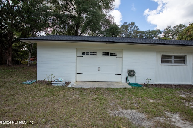 garage featuring a yard