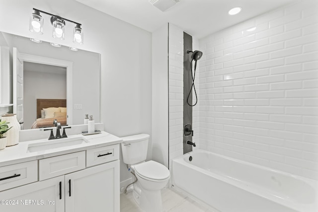 full bathroom featuring vanity, toilet, and tiled shower / bath