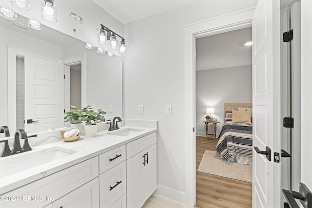 bathroom with hardwood / wood-style floors and vanity