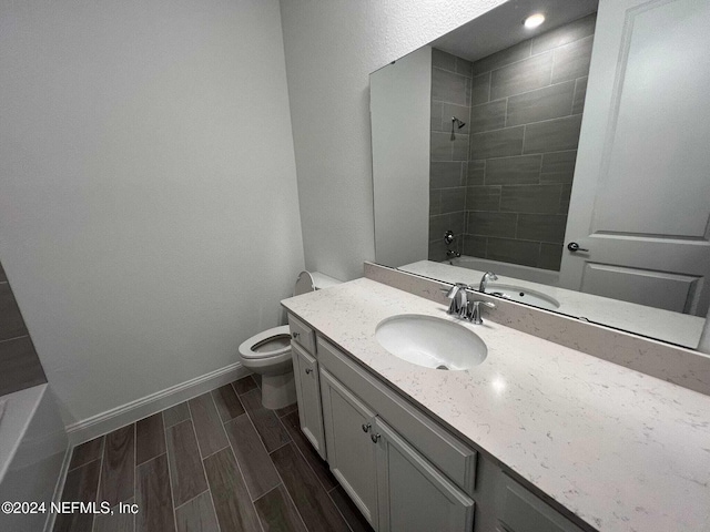 full bathroom with toilet, vanity, and tiled shower / bath