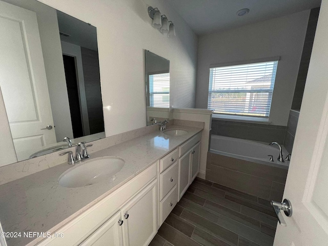 bathroom with vanity and a bathtub