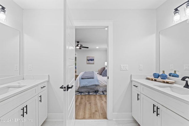 bathroom featuring wood-type flooring, vanity, and ceiling fan