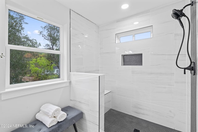 bathroom with plenty of natural light and tiled shower