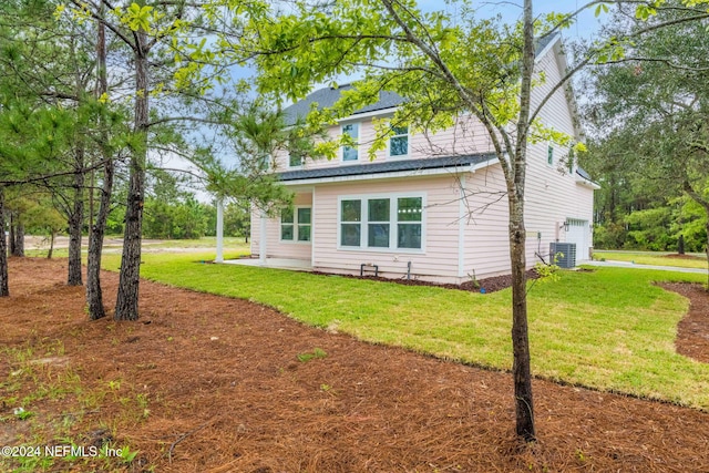 view of home's exterior featuring a garage and a lawn