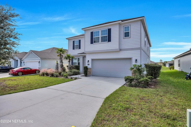 view of front property featuring a front yard and a garage