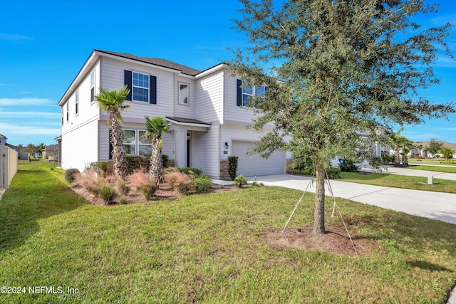 view of front of home featuring a garage and a front yard