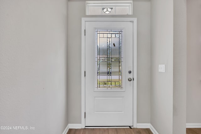 doorway to outside featuring hardwood / wood-style flooring and plenty of natural light