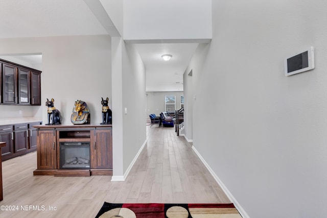 corridor with light hardwood / wood-style floors