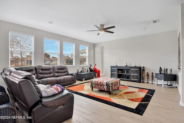 living room featuring ceiling fan and light hardwood / wood-style flooring