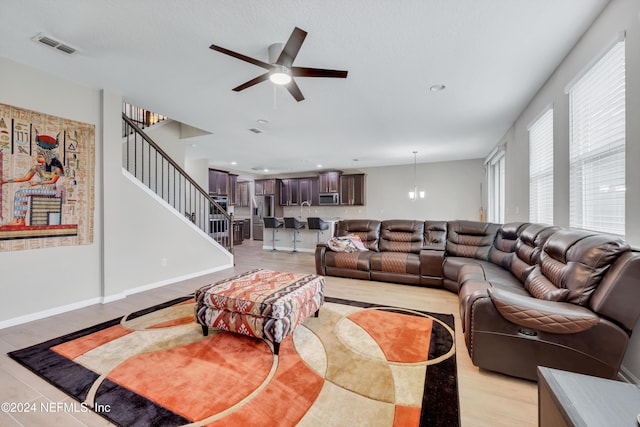 living room featuring ceiling fan and light wood-type flooring