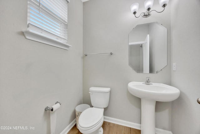 bathroom featuring wood-type flooring, toilet, and sink