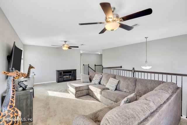 living room featuring light carpet and ceiling fan