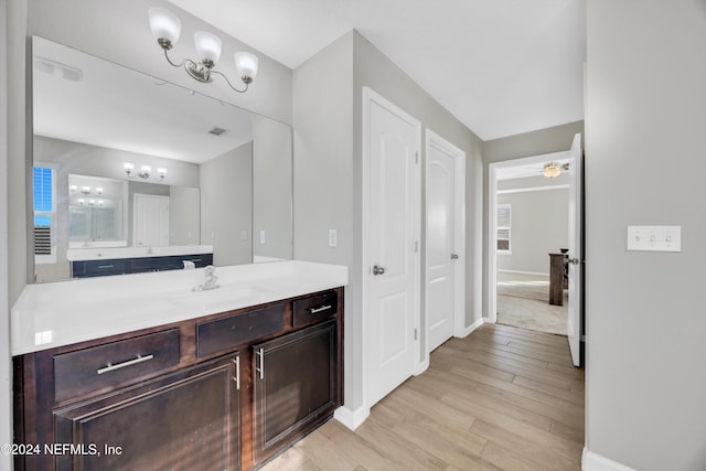 bathroom with vanity, ceiling fan, and wood-type flooring