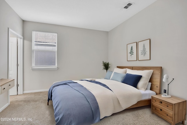 bedroom featuring light carpet