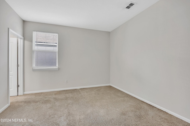 unfurnished room featuring light colored carpet