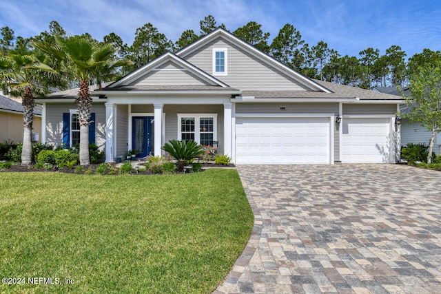 view of front of property with a garage and a front yard