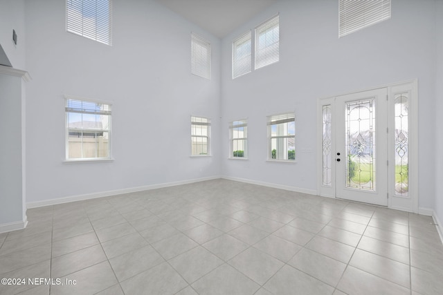 entrance foyer with a high ceiling and light tile patterned floors