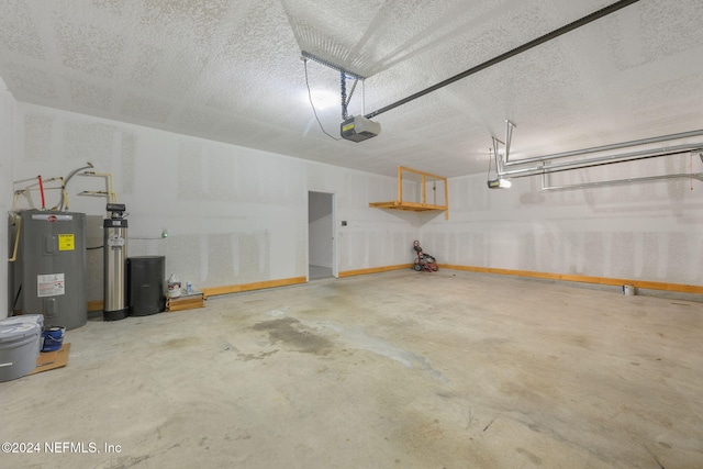 garage with electric water heater and a garage door opener