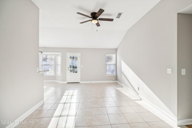 interior space with ceiling fan, light tile patterned flooring, and lofted ceiling