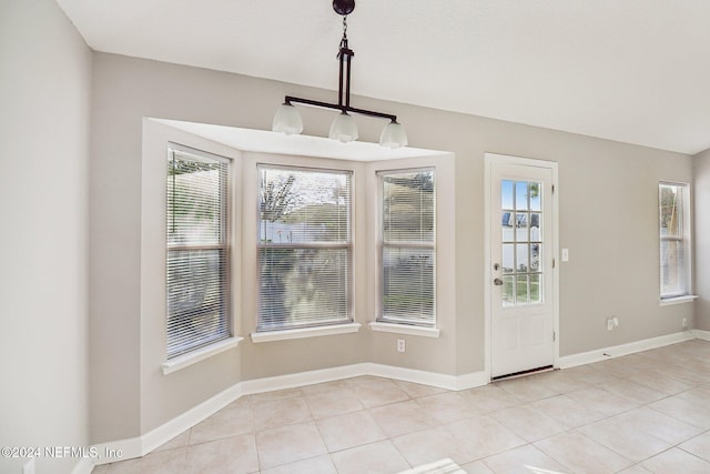 unfurnished dining area with light tile patterned floors