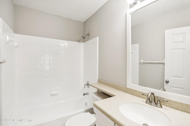 full bathroom with vanity, toilet, a textured ceiling, and bathing tub / shower combination