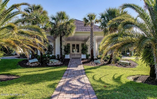 mediterranean / spanish home featuring french doors and a front yard