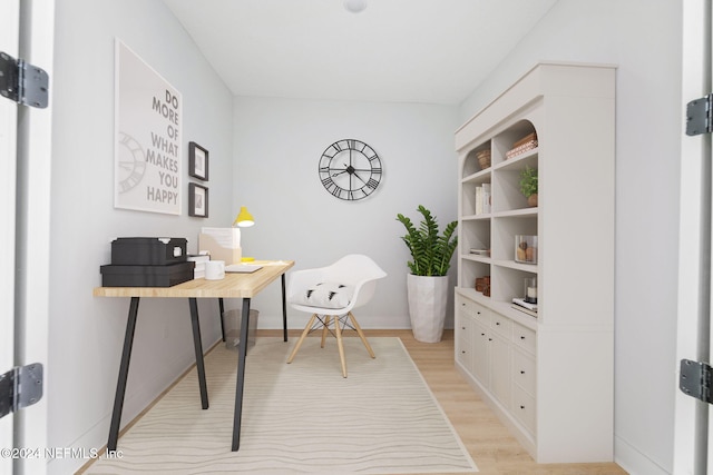 office with light wood-type flooring