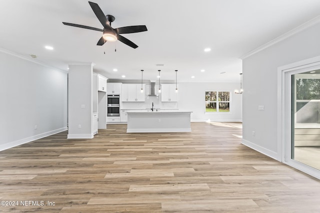 unfurnished living room with light hardwood / wood-style floors, ceiling fan with notable chandelier, and ornamental molding