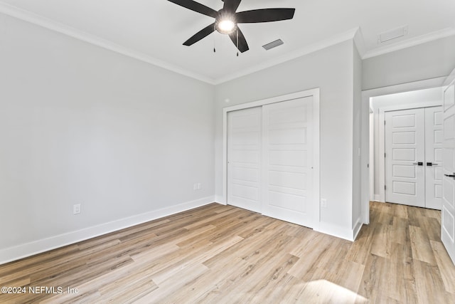 unfurnished bedroom with crown molding, a closet, ceiling fan, and light hardwood / wood-style floors