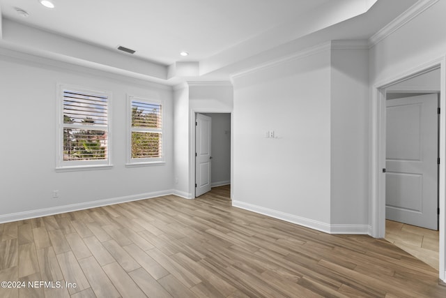 unfurnished room featuring light hardwood / wood-style flooring and ornamental molding