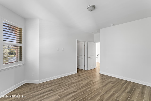 spare room with hardwood / wood-style floors