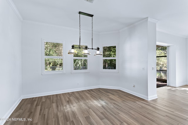 spare room featuring light wood-type flooring and ornamental molding