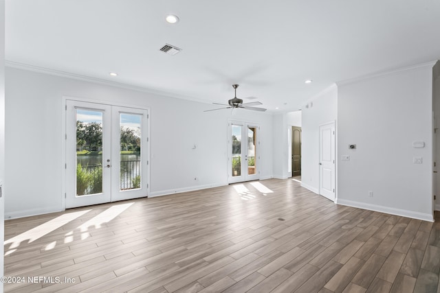 unfurnished living room with french doors, light hardwood / wood-style floors, ceiling fan, and crown molding