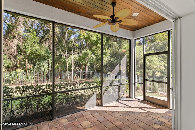 unfurnished sunroom with ceiling fan and wood ceiling