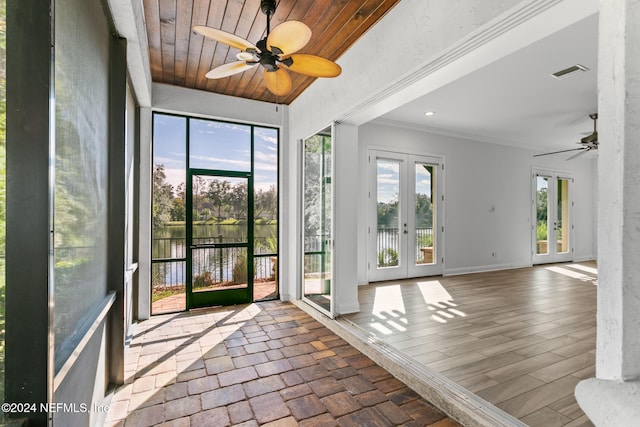 interior space featuring ceiling fan, french doors, a water view, and wooden ceiling