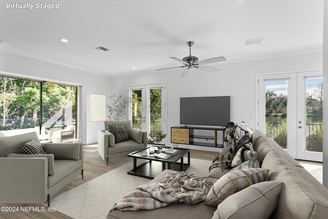 living room with crown molding, french doors, ceiling fan, and light hardwood / wood-style flooring