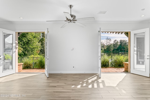 entryway featuring ornamental molding, light hardwood / wood-style flooring, and a healthy amount of sunlight