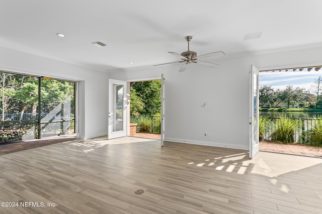 unfurnished room featuring ceiling fan, light hardwood / wood-style flooring, and ornamental molding