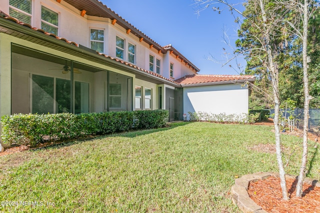 view of yard with ceiling fan