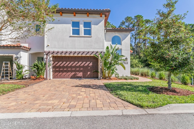 mediterranean / spanish-style home featuring a garage