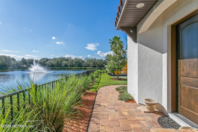 view of patio with a water view