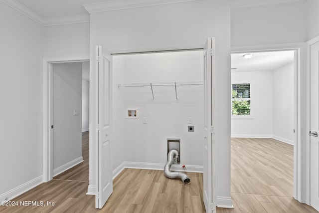 washroom featuring washer hookup, electric dryer hookup, light hardwood / wood-style floors, and crown molding