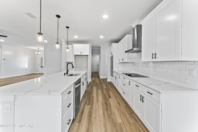 kitchen featuring wall chimney range hood and white cabinets