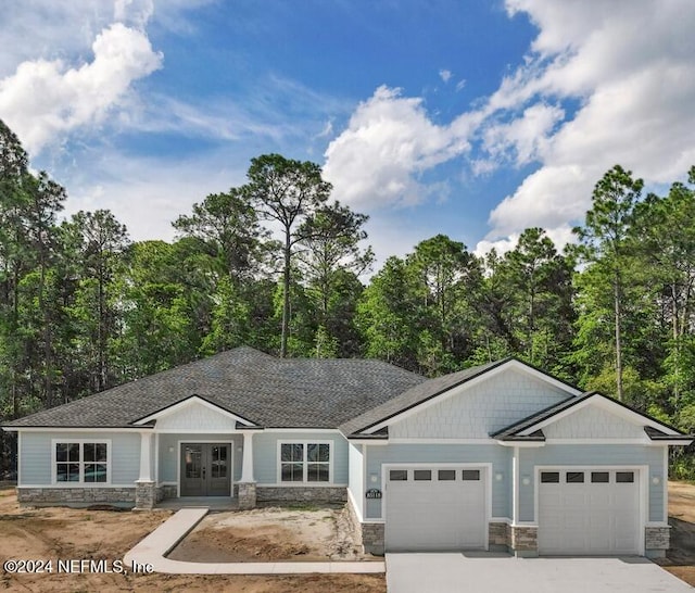 craftsman-style home with a garage and french doors